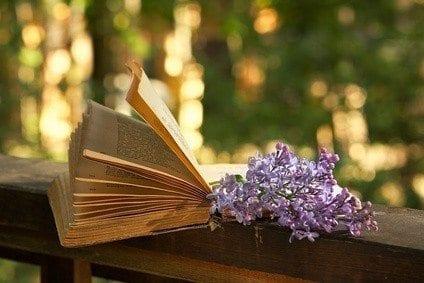 book of poetry and  lilac branch